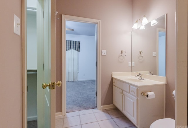 bathroom with tile patterned flooring, vanity, and toilet