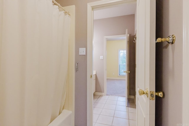 bathroom featuring tile patterned floors and shower / bath combo with shower curtain