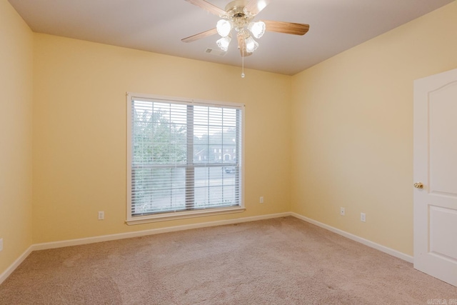 carpeted empty room featuring ceiling fan