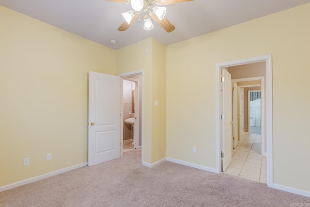 unfurnished bedroom featuring ceiling fan and light colored carpet