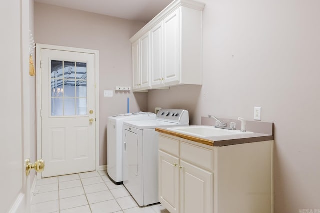 laundry area featuring cabinets, light tile patterned floors, separate washer and dryer, and sink