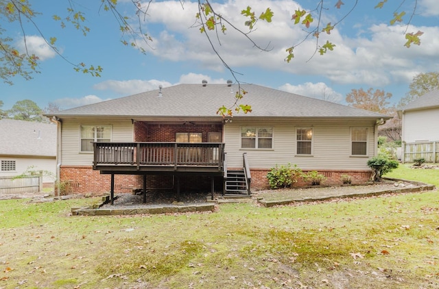 back of house with a wooden deck and a lawn