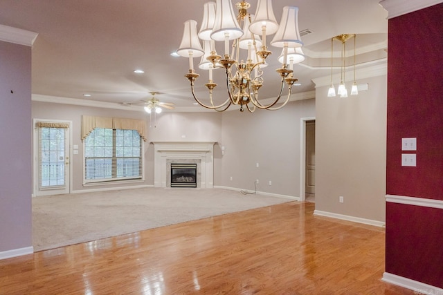 unfurnished living room featuring ceiling fan, light hardwood / wood-style flooring, a high end fireplace, and crown molding