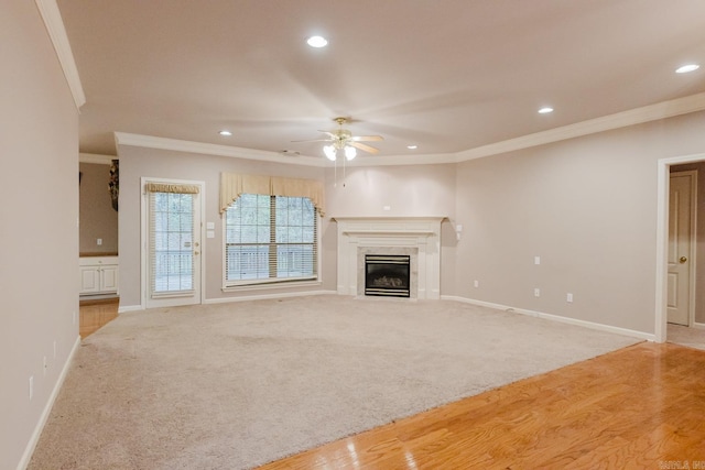 unfurnished living room with ceiling fan, light hardwood / wood-style floors, and crown molding