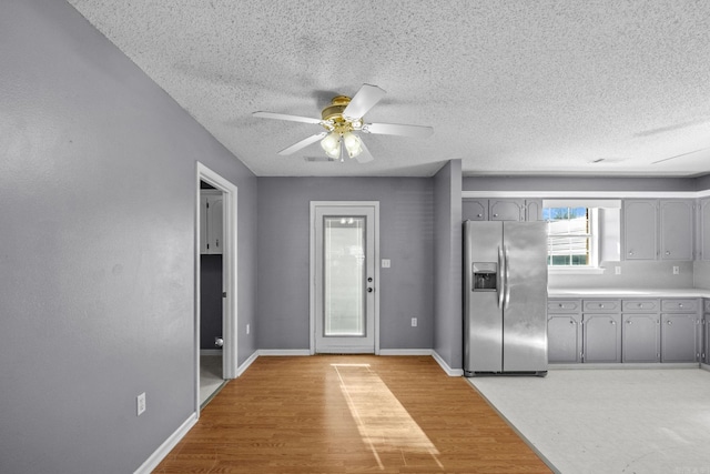 interior space with hardwood / wood-style floors, a textured ceiling, and ceiling fan