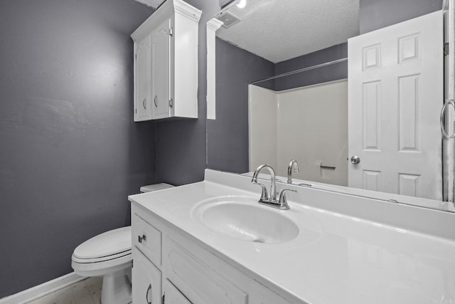 bathroom featuring vanity, toilet, a textured ceiling, and walk in shower