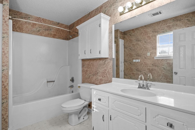 full bathroom with toilet, vanity, a textured ceiling, and tub / shower combination