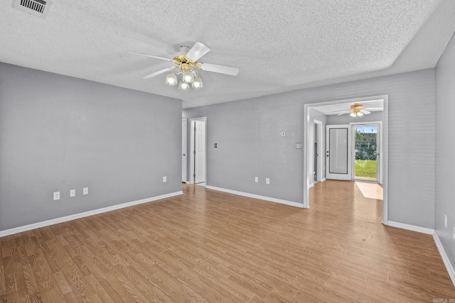 unfurnished room with ceiling fan, light hardwood / wood-style floors, and a textured ceiling