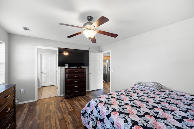 bedroom featuring stainless steel fridge, dark hardwood / wood-style flooring, and ceiling fan