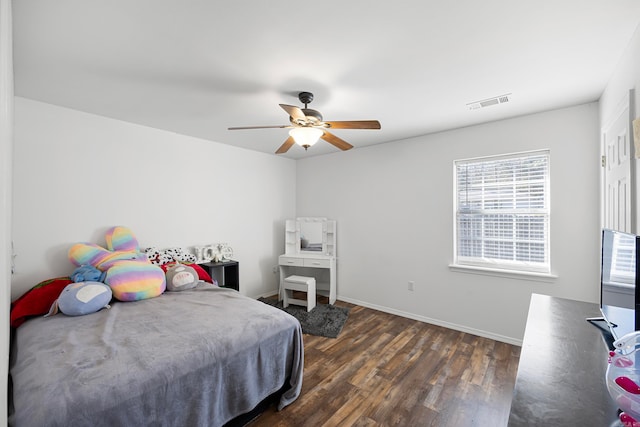 bedroom with dark hardwood / wood-style flooring and ceiling fan