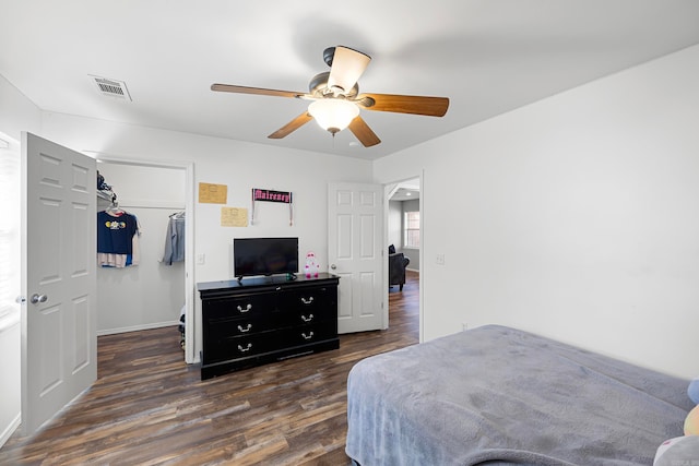 bedroom with a closet, ceiling fan, and dark hardwood / wood-style flooring