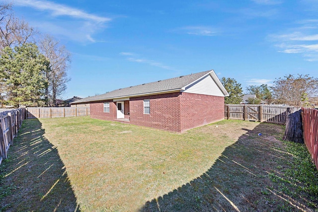 back of property featuring a lawn