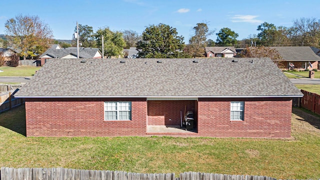 back of house featuring a patio and a lawn