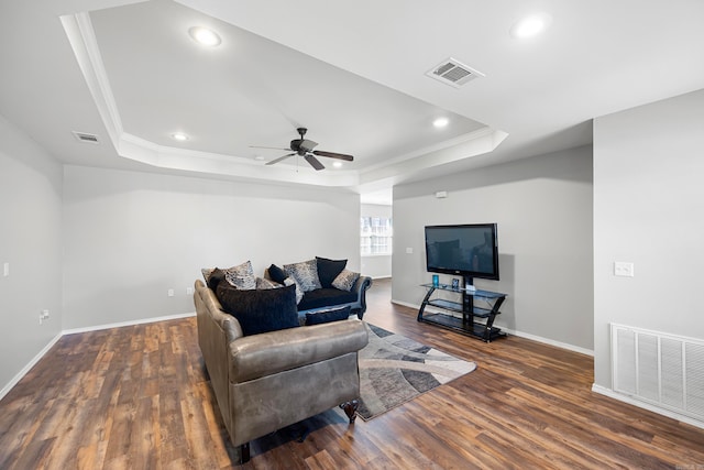 living room featuring dark hardwood / wood-style flooring, ceiling fan, and ornamental molding