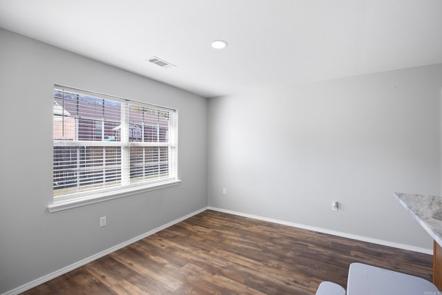 spare room with dark hardwood / wood-style flooring