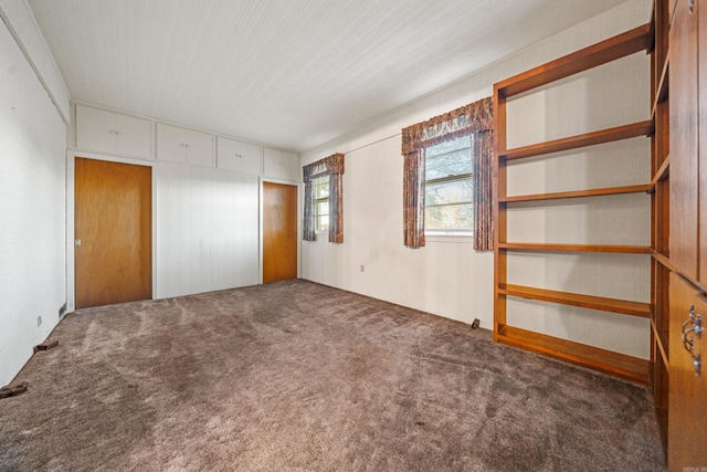 unfurnished bedroom featuring dark carpet