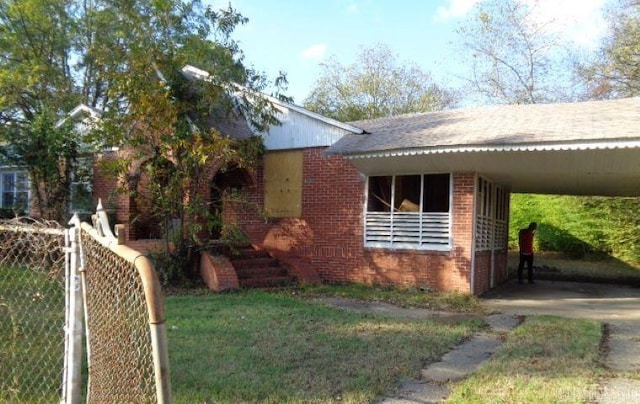 view of property exterior with a carport and a lawn