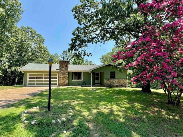 ranch-style house featuring a front yard and a garage