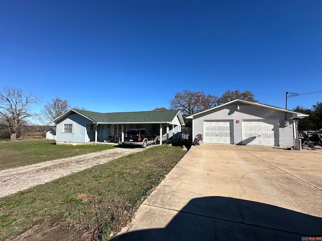 view of front facade featuring a carport, a garage, and a front lawn