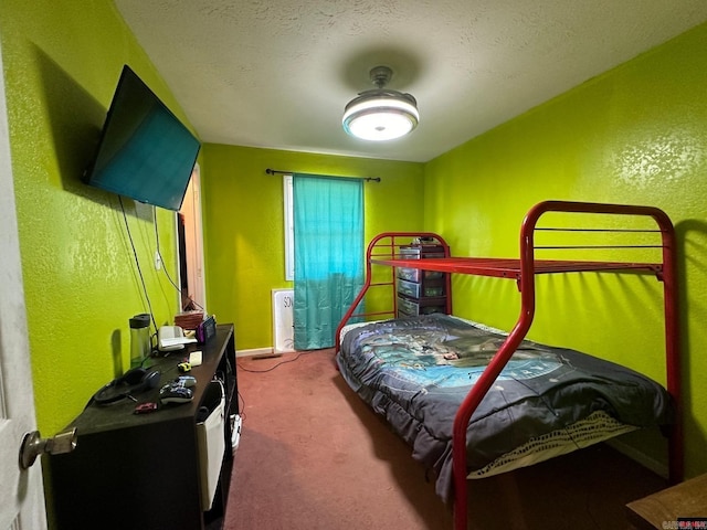 bedroom featuring carpet flooring and a textured ceiling