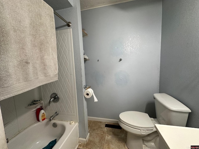 full bathroom featuring toilet, tile patterned flooring, vanity, and tiled shower / bath