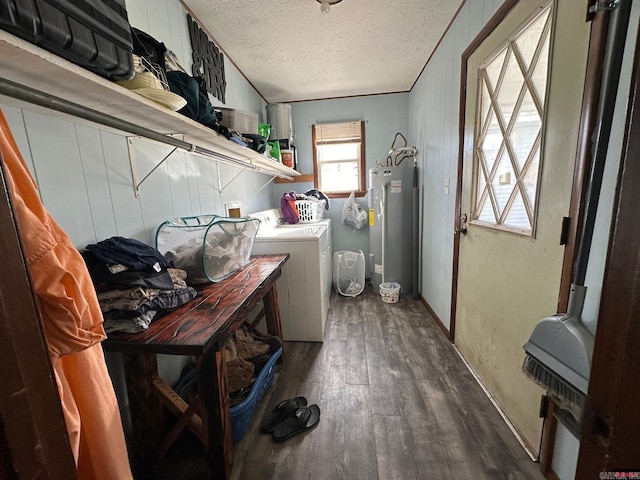 washroom with a textured ceiling, crown molding, dark wood-type flooring, water heater, and washing machine and clothes dryer