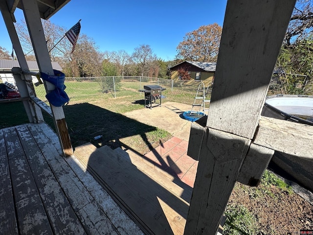 deck featuring a lawn and area for grilling