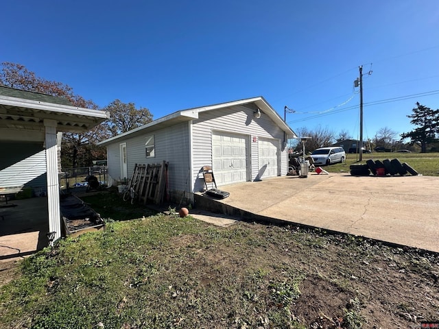 view of property exterior with a garage and an outdoor structure