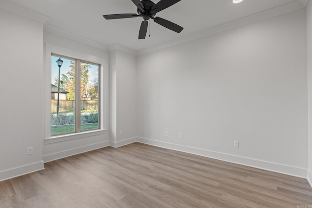 spare room with light wood-type flooring, ceiling fan, and ornamental molding