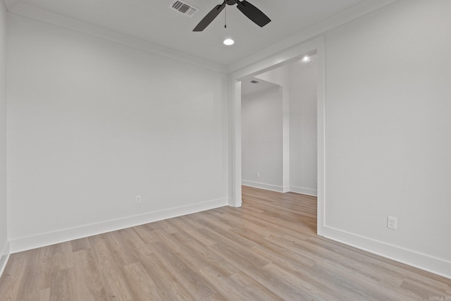 empty room with light hardwood / wood-style floors, ceiling fan, and crown molding