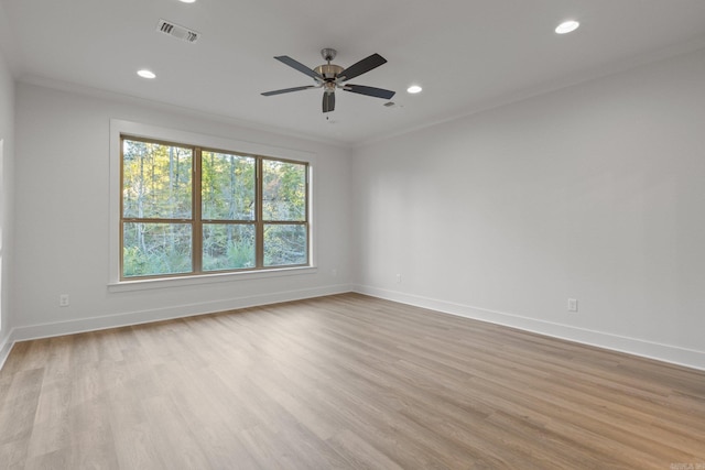 empty room with light hardwood / wood-style floors, ceiling fan, and crown molding