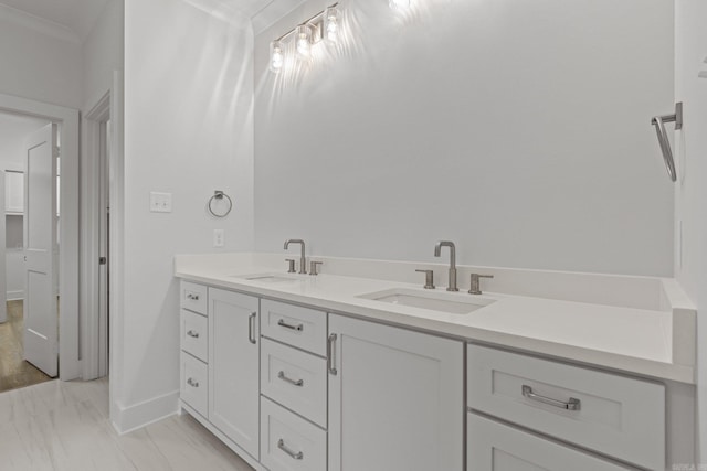 bathroom featuring hardwood / wood-style floors, vanity, and crown molding