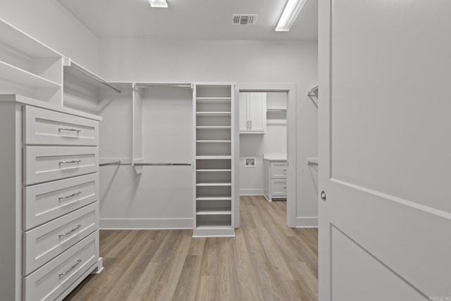 walk in closet featuring light hardwood / wood-style flooring