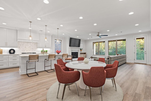 dining room with ceiling fan and light wood-type flooring