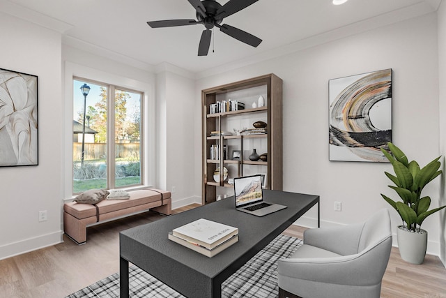 home office featuring light hardwood / wood-style floors, ceiling fan, and ornamental molding