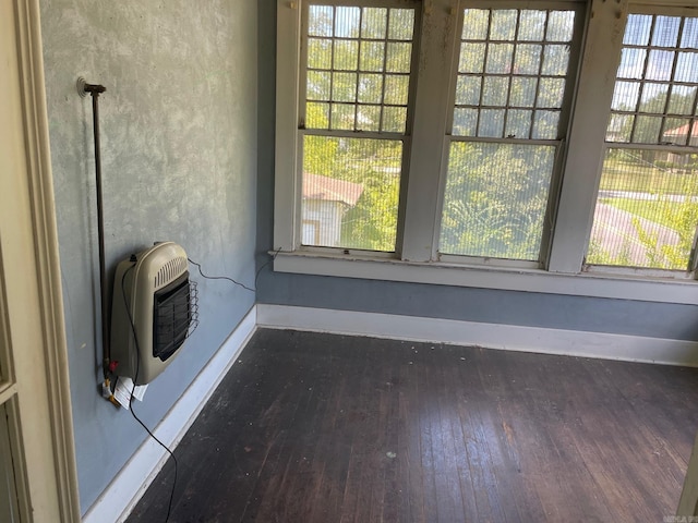 interior details featuring heating unit and hardwood / wood-style flooring