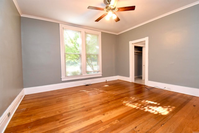 unfurnished room featuring ceiling fan, hardwood / wood-style floors, and ornamental molding