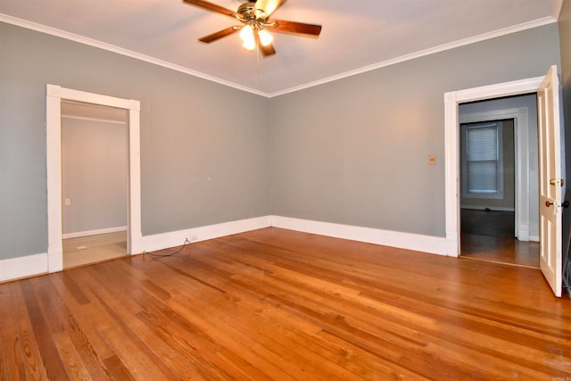 empty room with hardwood / wood-style flooring, ceiling fan, and ornamental molding