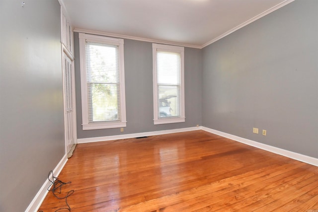 unfurnished room with light hardwood / wood-style flooring and ornamental molding