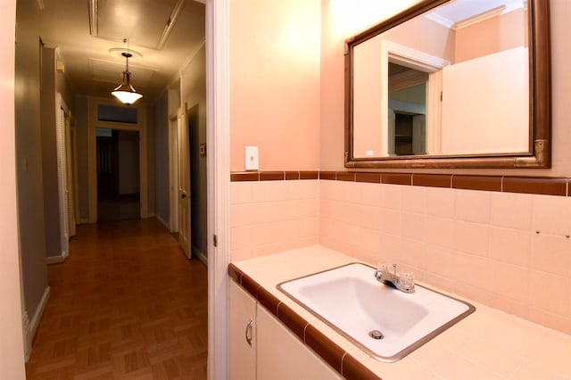 bathroom with vanity, parquet floors, and crown molding