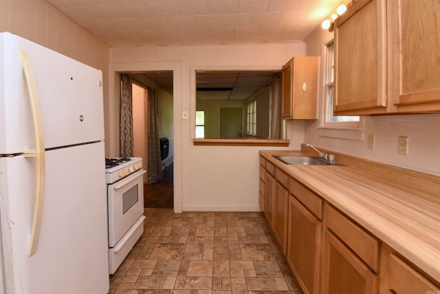 kitchen with sink, wooden counters, and white appliances