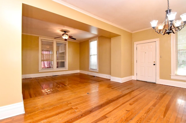 foyer entrance featuring ceiling fan with notable chandelier, wood-type flooring, and crown molding