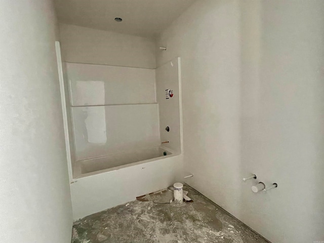 bathroom featuring shower / bathtub combination and concrete floors