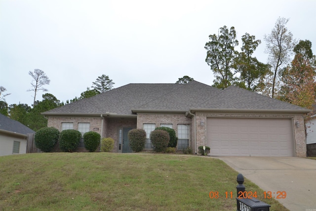 single story home with a front lawn and a garage