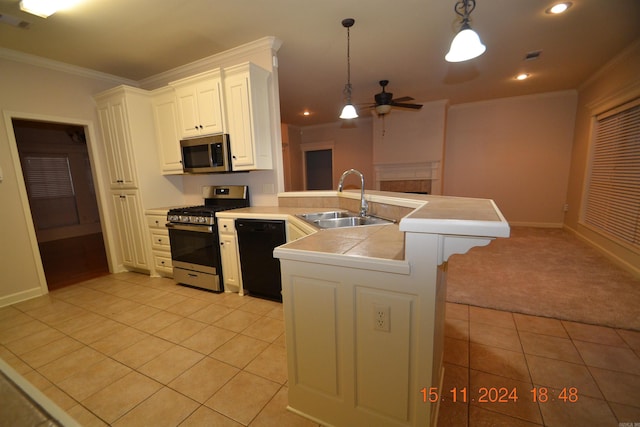 kitchen featuring white cabinetry, sink, hanging light fixtures, stainless steel appliances, and kitchen peninsula