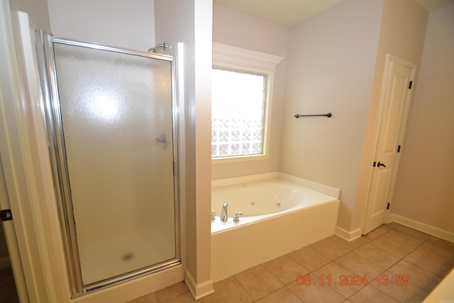 bathroom featuring tile patterned floors and separate shower and tub