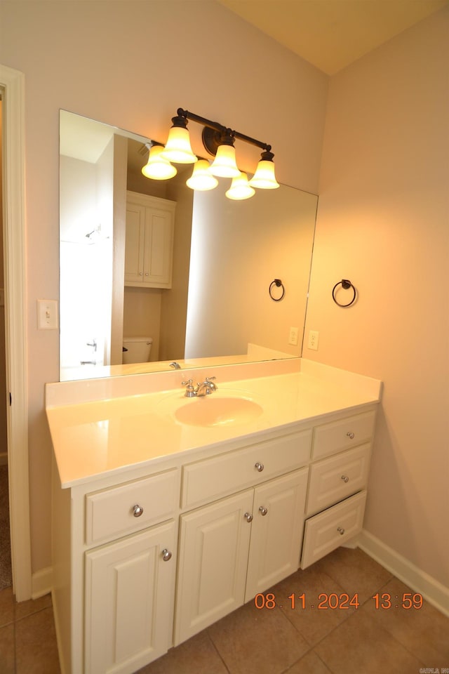 bathroom featuring toilet, vanity, and tile patterned floors