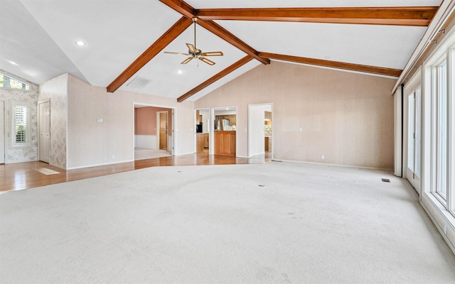 unfurnished living room with beamed ceiling, ceiling fan, light hardwood / wood-style floors, and high vaulted ceiling