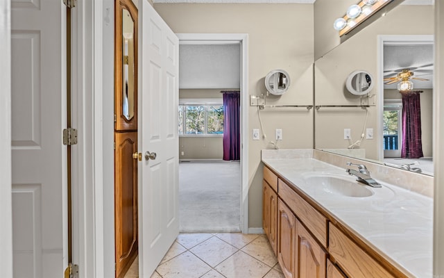 bathroom with tile patterned floors, ceiling fan, vanity, and a textured ceiling