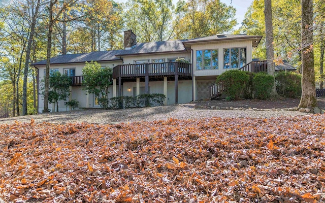 back of property with a wooden deck